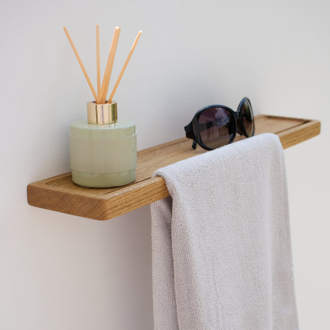 Wyjątkowo trwały i stylowy wieszak ścienny z półką z dębu lub orzecha amerykańskiego pozwala wygodnie odwiesić ubrania, ręczniki czy akcesoria, a dodatkowa półka zapewnia miejsce na dekoracje, kosmetyki lub klucze. Idealny do małych i dużych przestrzeni.